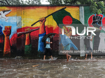 Residents of the city suffer from continuous rain in Dhaka, Bangladesh, on October 5, 2024. (