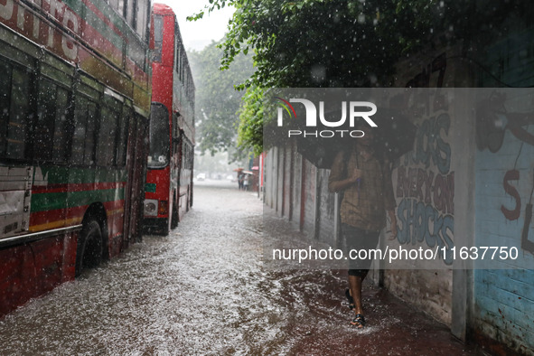 Residents of the city suffer from continuous rain in Dhaka, Bangladesh, on October 5, 2024. 