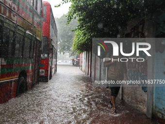 Residents of the city suffer from continuous rain in Dhaka, Bangladesh, on October 5, 2024. (