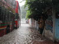 Residents of the city suffer from continuous rain in Dhaka, Bangladesh, on October 5, 2024. (