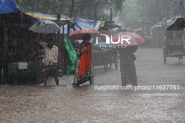 Residents of the city suffer from continuous rain in Dhaka, Bangladesh, on October 5, 2024. 