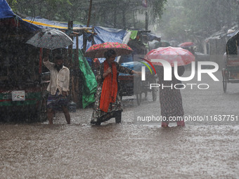 Residents of the city suffer from continuous rain in Dhaka, Bangladesh, on October 5, 2024. (