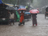 Residents of the city suffer from continuous rain in Dhaka, Bangladesh, on October 5, 2024. (