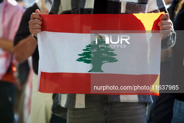 A protester holds a Lebanese flag. Hundreds of people demonstrate in Toulouse, France, on October 5, 2024, in support of Gazans, the Gaza St...