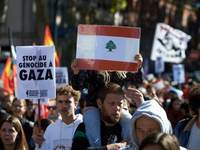 A girl holds a Lebanese flag while on the shoulders of her father. Hundreds of people demonstrate in Toulouse, France, on October 5, 2024, i...