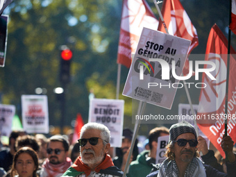 A man holds a placard reading 'Stop the genocide in Gaza'. Hundreds of people demonstrate in Toulouse, France, on October 5, 2024, in suppor...