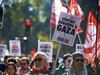 A man holds a placard reading 'Stop the genocide in Gaza'. Hundreds of people demonstrate in Toulouse, France, on October 5, 2024, in suppor...