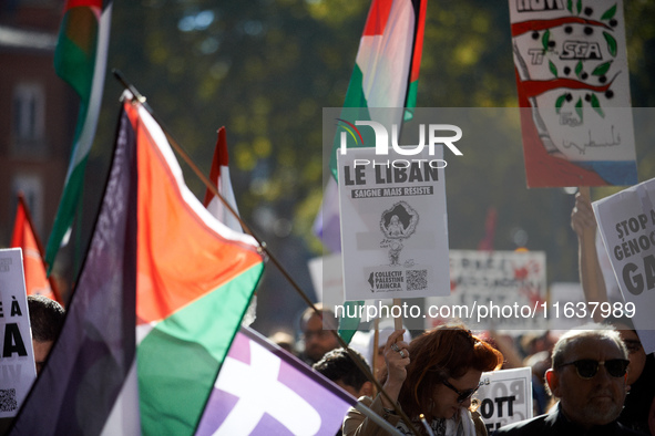 A woman holds a placard reading 'Lebanon bleeds but resists'. Hundreds of people demonstrate in Toulouse, France, on October 5, 2024, in sup...