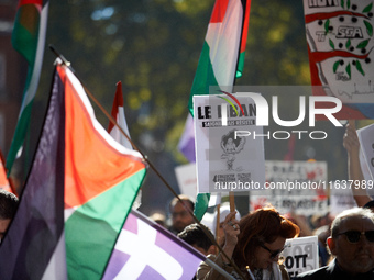 A woman holds a placard reading 'Lebanon bleeds but resists'. Hundreds of people demonstrate in Toulouse, France, on October 5, 2024, in sup...