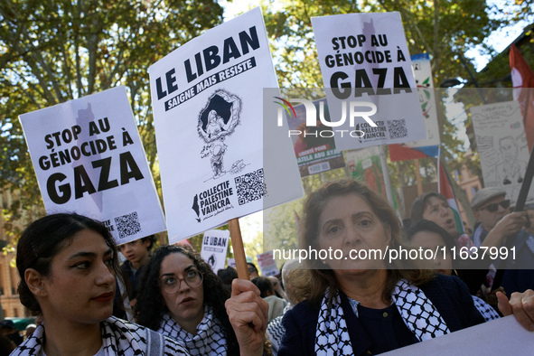 A woman holds a placard reading 'Lebanon bleeds but resists'. Hundreds of people demonstrate in Toulouse, France, on October 5, 2024, in sup...