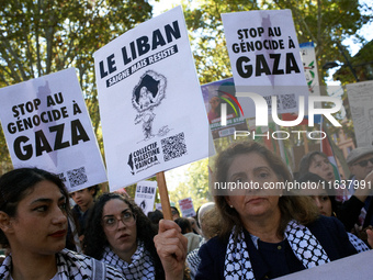 A woman holds a placard reading 'Lebanon bleeds but resists'. Hundreds of people demonstrate in Toulouse, France, on October 5, 2024, in sup...