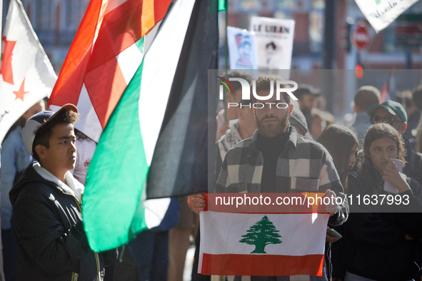 A protester holds a Lebanese flag during the march. Hundreds of people demonstrate in Toulouse, France, on October 5, 2024, in support of Ga...