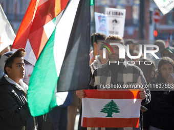 A protester holds a Lebanese flag during the march. Hundreds of people demonstrate in Toulouse, France, on October 5, 2024, in support of Ga...