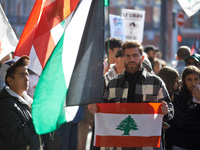 A protester holds a Lebanese flag during the march. Hundreds of people demonstrate in Toulouse, France, on October 5, 2024, in support of Ga...