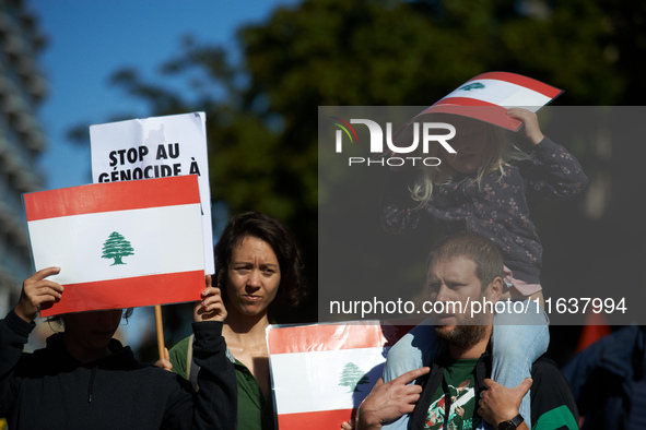 People hold the Lebanese flag. Hundreds of people demonstrate in Toulouse, France, on October 5, 2024, in support of Gazans, the Gaza Strip,...