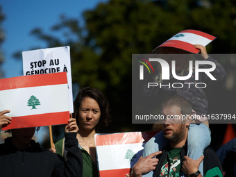 People hold the Lebanese flag. Hundreds of people demonstrate in Toulouse, France, on October 5, 2024, in support of Gazans, the Gaza Strip,...