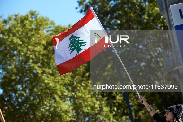 A protester waves the Lebanese flag during the march. Hundreds of people demonstrate in Toulouse, France, on October 5, 2024, in support of...