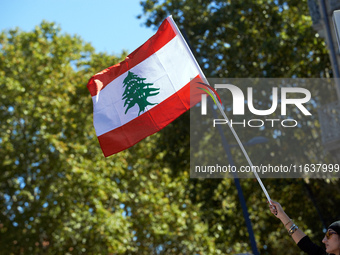 A protester waves the Lebanese flag during the march. Hundreds of people demonstrate in Toulouse, France, on October 5, 2024, in support of...