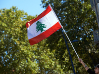 A protester waves the Lebanese flag during the march. Hundreds of people demonstrate in Toulouse, France, on October 5, 2024, in support of...