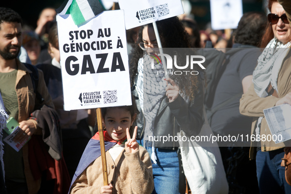 A girl makes the 'V' sign while holding a placard reading 'Stop to the genocide in Gaza'. Hundreds of people demonstrate in Toulouse, France...