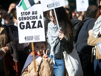 A girl makes the 'V' sign while holding a placard reading 'Stop to the genocide in Gaza'. Hundreds of people demonstrate in Toulouse, France...