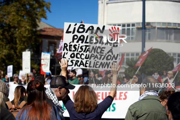 A protester holds a placard reading 'Lebanon, Palestine, resistance to the Israeli occupation'. Hundreds of people demonstrate in Toulouse,...