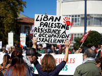 A protester holds a placard reading 'Lebanon, Palestine, resistance to the Israeli occupation'. Hundreds of people demonstrate in Toulouse,...