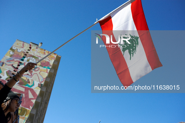 A protester waves the Lebanese flag. Hundreds of people demonstrate in Toulouse, France, on October 5, 2024, in support of Gazans, the Gaza...