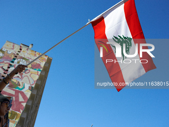 A protester waves the Lebanese flag. Hundreds of people demonstrate in Toulouse, France, on October 5, 2024, in support of Gazans, the Gaza...