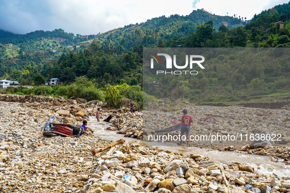 Children search for their belongings in damaged houses due to Nakhu River flooding in the Bhardev region of southern Lalitpur, Nepal, on Oct...