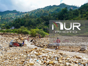 Children search for their belongings in damaged houses due to Nakhu River flooding in the Bhardev region of southern Lalitpur, Nepal, on Oct...