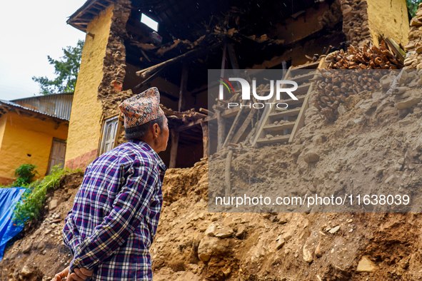 An elderly man stands looking at his home damaged by flooding from the Nakhu River in the Bhardev region of southern Lalitpur, Nepal, on Oct...