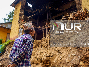 An elderly man stands looking at his home damaged by flooding from the Nakhu River in the Bhardev region of southern Lalitpur, Nepal, on Oct...