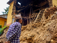 An elderly man stands looking at his home damaged by flooding from the Nakhu River in the Bhardev region of southern Lalitpur, Nepal, on Oct...