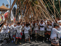 Balinese men make pyramid-like structures using long wooden sticks during the Mekotek ritual in Munggu Village, Bali, Indonesia, on October...