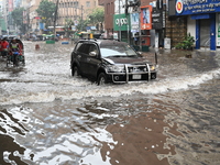 Vehicles and rickshaws drive with passengers through the waterlogged streets of Dhaka, Bangladesh, on October 5, 2024, after heavy rainfalls...