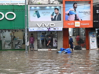 Vehicles and rickshaws drive with passengers through the waterlogged streets of Dhaka, Bangladesh, on October 5, 2024, after heavy rainfalls...