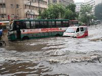 Vehicles and rickshaws drive with passengers through the waterlogged streets of Dhaka, Bangladesh, on October 5, 2024, after heavy rainfalls...