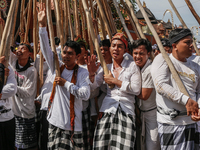 Balinese men make pyramid-like structures using long wooden sticks during the Mekotek ritual in Munggu Village, Bali, Indonesia, on October...