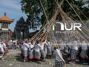 Balinese men make pyramid-like structures using long wooden sticks during the Mekotek ritual in Munggu Village, Bali, Indonesia, on October...