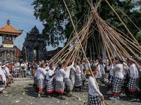 Balinese men make pyramid-like structures using long wooden sticks during the Mekotek ritual in Munggu Village, Bali, Indonesia, on October...