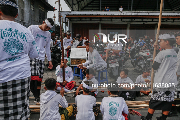 Balinese men carry long wooden sticks and take part in the Mekotek ritual in Munggu Village, Bali, Indonesia, on October 5, 2024. Mekotek is...