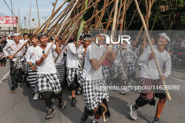 Balinese men make pyramid-like structures using long wooden sticks during the Mekotek ritual in Munggu Village, Bali, Indonesia, on October...