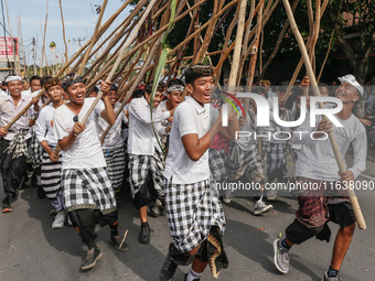 Balinese men make pyramid-like structures using long wooden sticks during the Mekotek ritual in Munggu Village, Bali, Indonesia, on October...