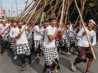 Balinese men make pyramid-like structures using long wooden sticks during the Mekotek ritual in Munggu Village, Bali, Indonesia, on October...