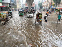 Vehicles and rickshaws drive with passengers through the waterlogged streets of Dhaka, Bangladesh, on October 5, 2024, after heavy rainfalls...