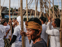 Balinese men carry long wooden sticks and take part in the Mekotek ritual in Munggu Village, Bali, Indonesia, on October 5, 2024. Mekotek is...