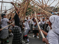 Balinese men make pyramid-like structures using long wooden sticks during the Mekotek ritual in Munggu Village, Bali, Indonesia, on October...