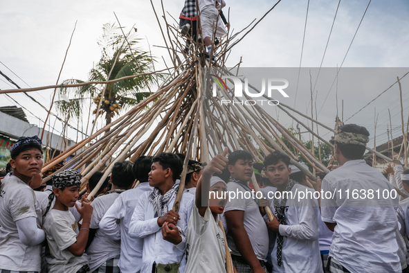 Balinese men make pyramid-like structures using long wooden sticks during the Mekotek ritual in Munggu Village, Bali, Indonesia, on October...