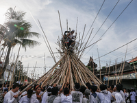 Balinese men climb pyramid-like structures using long wooden sticks during the Mekotek ritual in Munggu Village, Bali, Indonesia, on October...